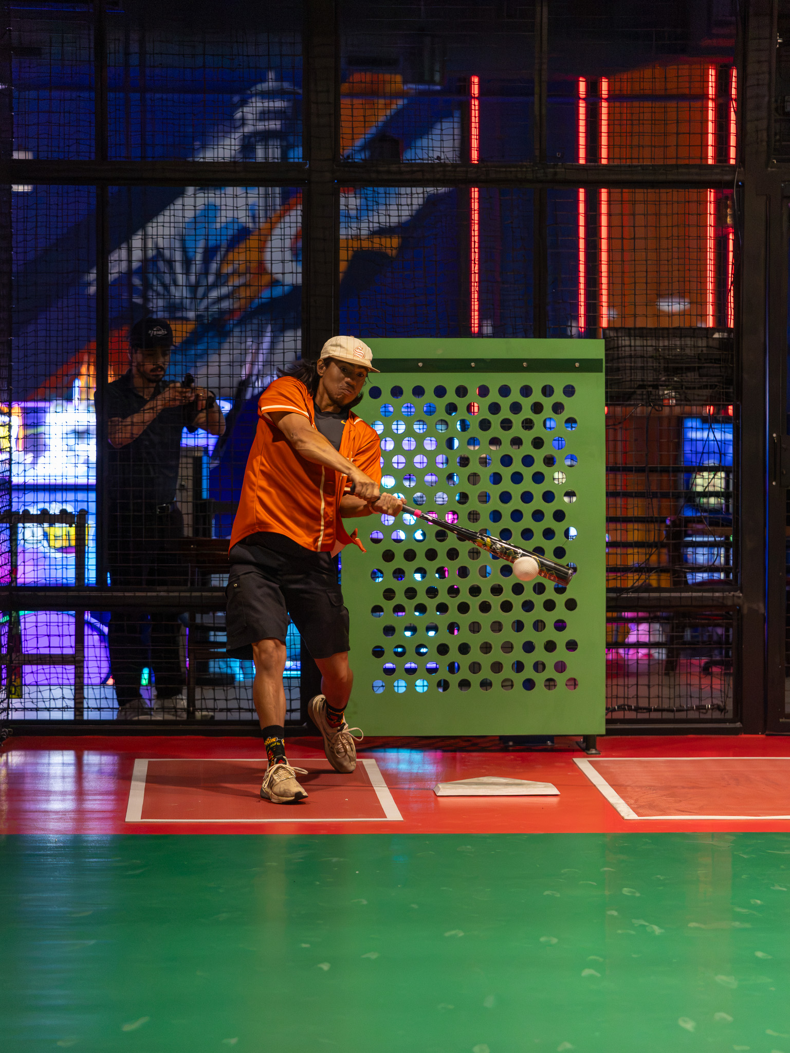 A guest hitting a pitch in the batting cages at Taroko Sports